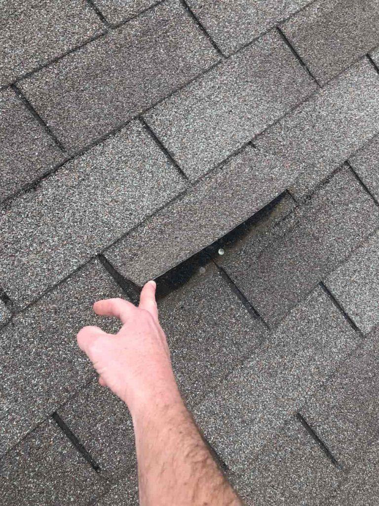Loose shingles from roof damage
